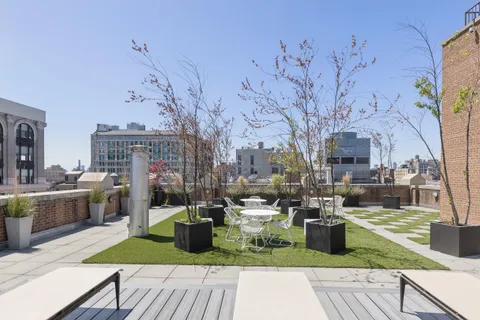 a view of a backyard with sitting area