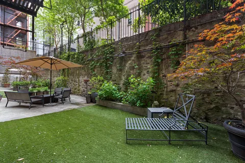 a view of a chair and table in the backyard