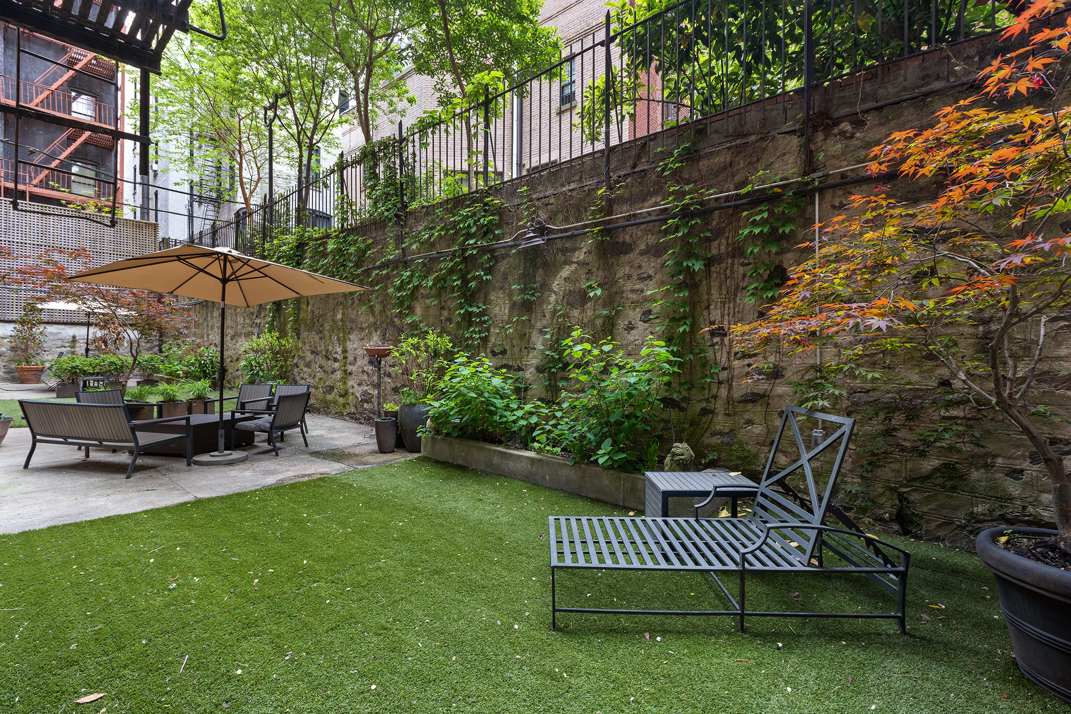 16 East 98th Street, Unit 7F Manhattan, NY 10029 - Photo 5 of 6 a view of a chair and table in the backyard