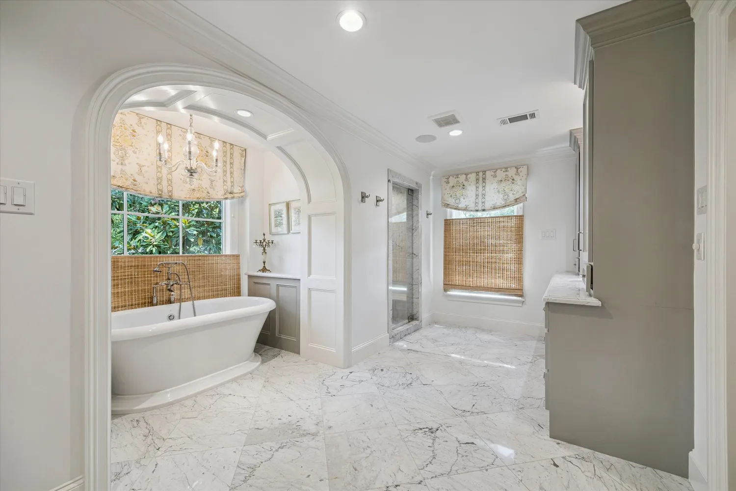 a spacious bathroom with a granite countertop sink a mirror and a shower
