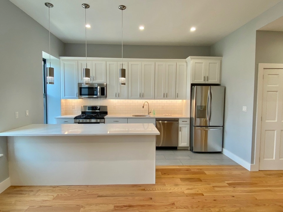 465 6th Avenue, Unit 2 Brooklyn, NY 11215 - Photo 2 of 10 a kitchen with kitchen island a counter top stainless steel appliances and cabinets