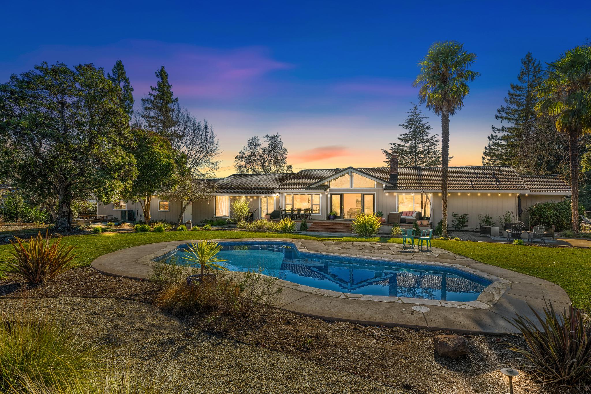 a view of a house with swimming pool yard and sitting area