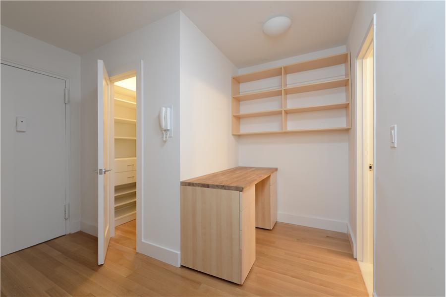 116 Central Park South, Unit 3G Manhattan, NY 10019 - Photo 2 of 8 a view of an empty room with wooden floor and a window