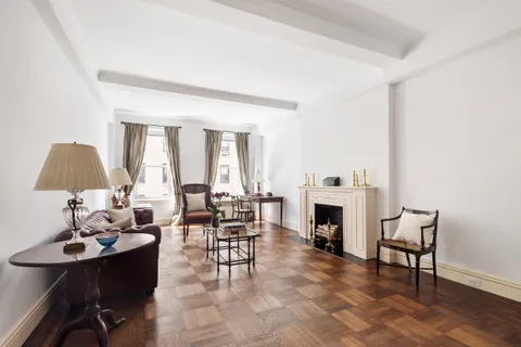 a living room with furniture a fireplace and a table