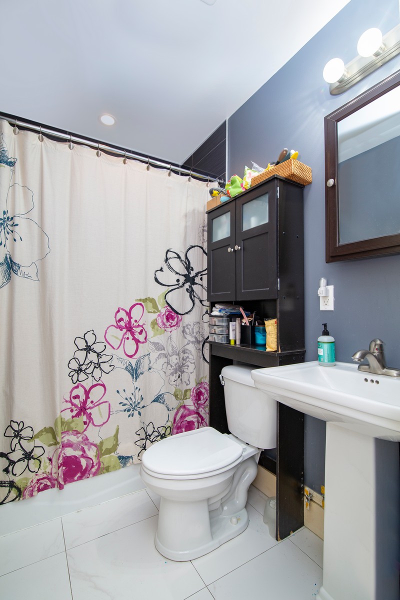 445 Rogers Avenue, Unit 1LF Brooklyn, NY 11225 - Photo 5 of 6 a bathroom with a sink toilet and shower