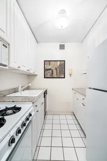 a kitchen with a stove cabinets and window