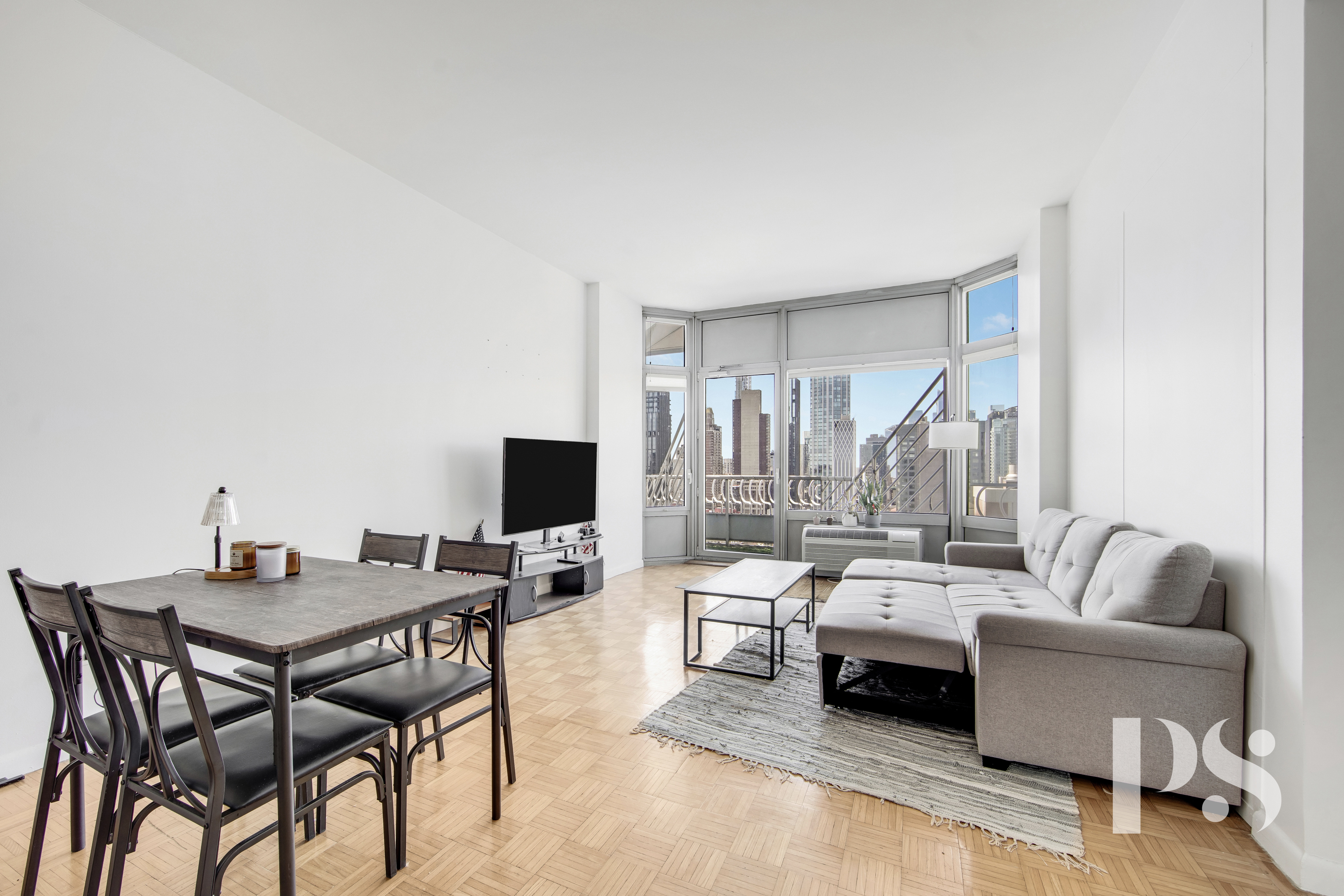 200 East 32nd Street, Unit 33C Manhattan, NY 10016 - Photo 3 of 12 a living room with furniture and a flat screen tv