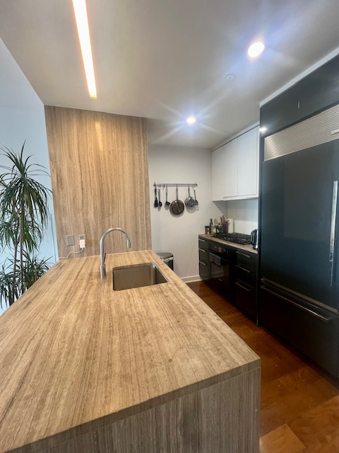 2 Northside Piers, Unit 26C Brooklyn, NY 11249 - Photo 11 of 21 a large bedroom with a bed and a potted plant