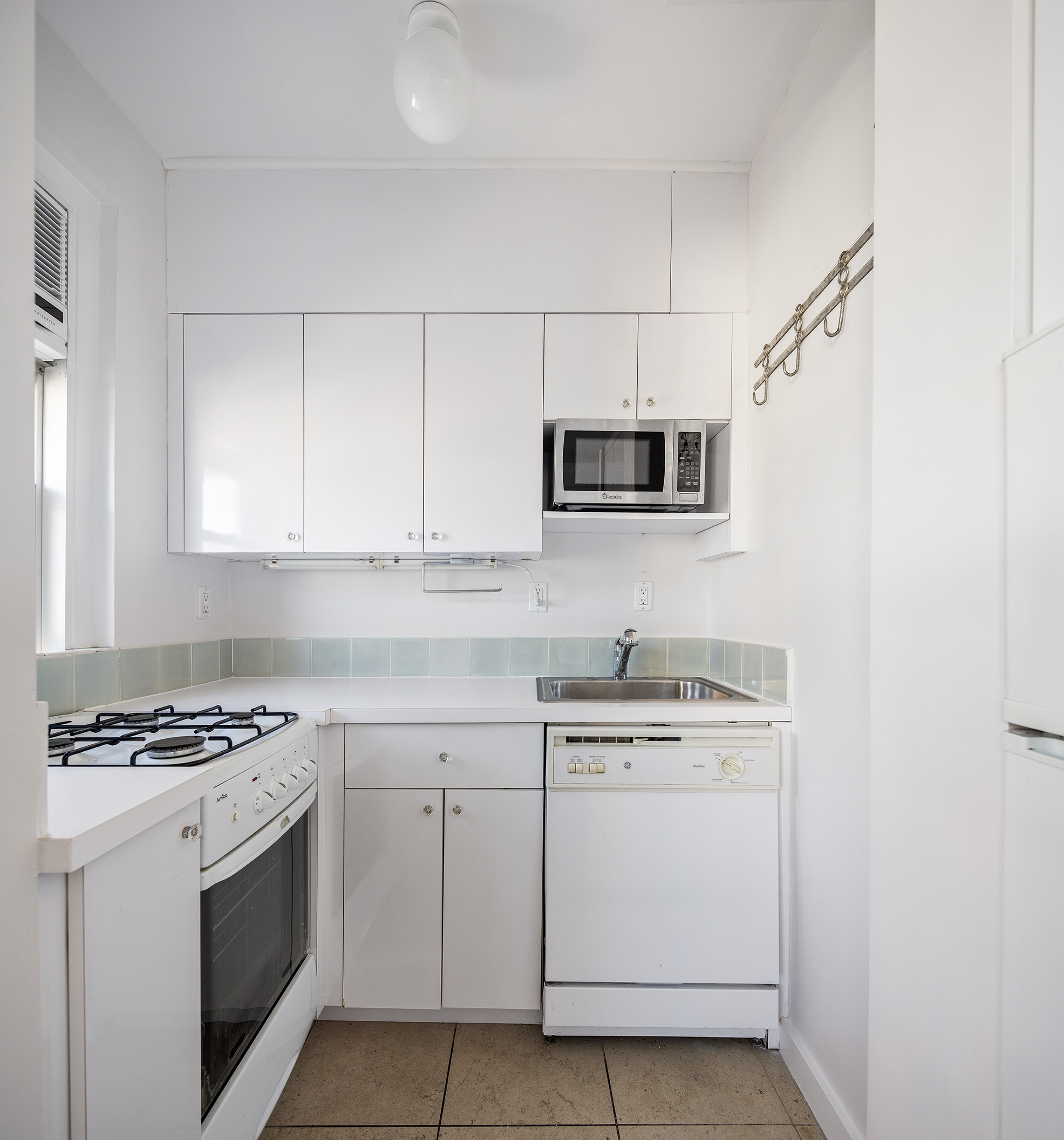 70 Remsen Street, Unit 10J Brooklyn, NY 11201 - Photo 6 of 11 a kitchen with cabinets stainless steel appliances and sink