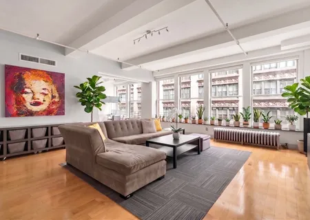 a living room with furniture and kitchen view