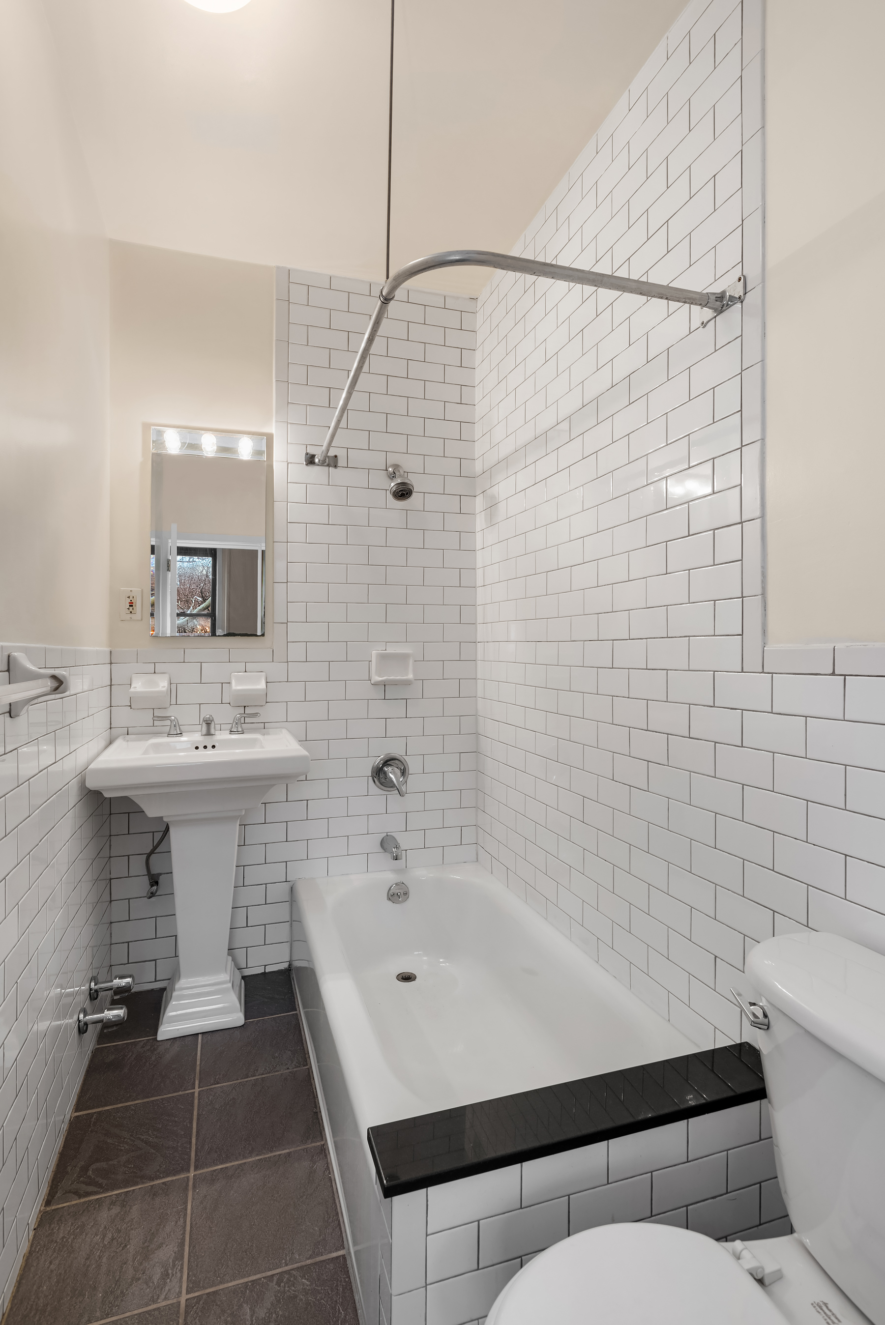 93 Barrow Street, Unit 4 Manhattan, NY 10014 - Photo 4 of 8 a bathroom with a sink a toilet and shower