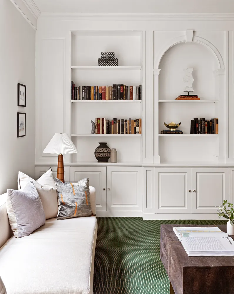 a living room with furniture and white walls