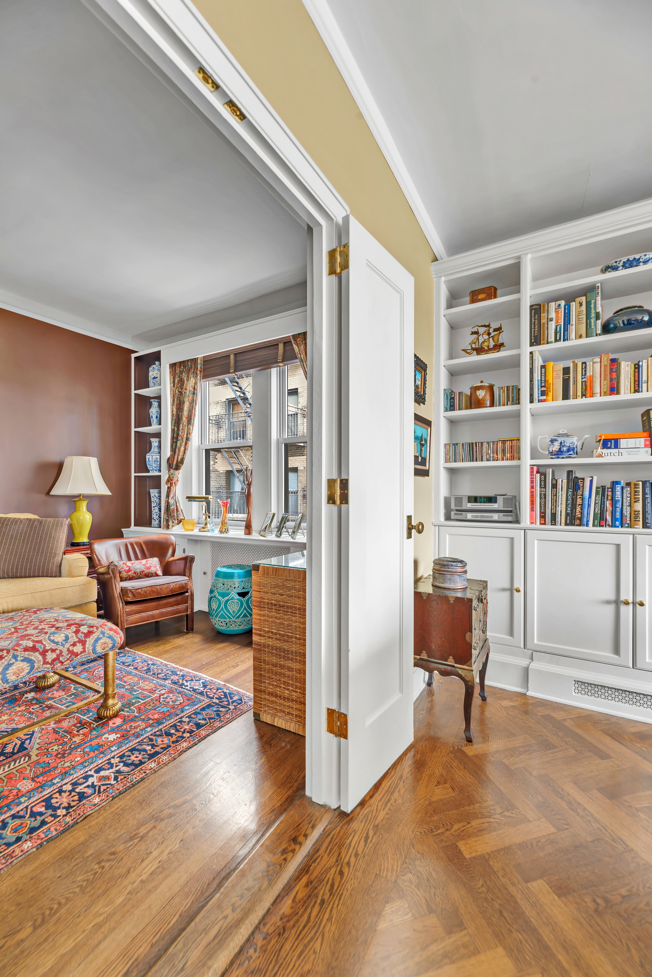 455 East 51st Street, Unit 6B Manhattan, NY 10022 - Photo 6 of 17 a bedroom with furniture and a book shelf
