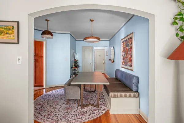 a very nice looking dining room with a rug and a chandelier