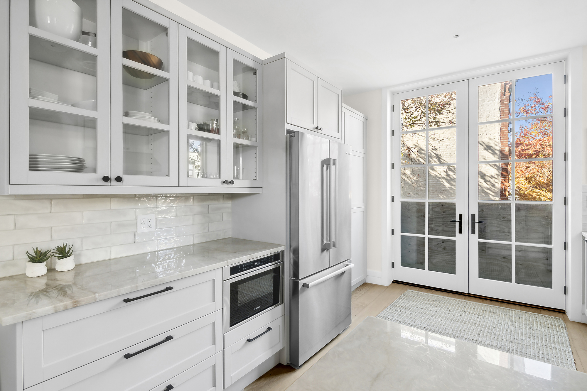 374 14th Street Brooklyn, NY 11215 - Photo 2 of 11 a kitchen with stainless steel appliances white cabinets and a window