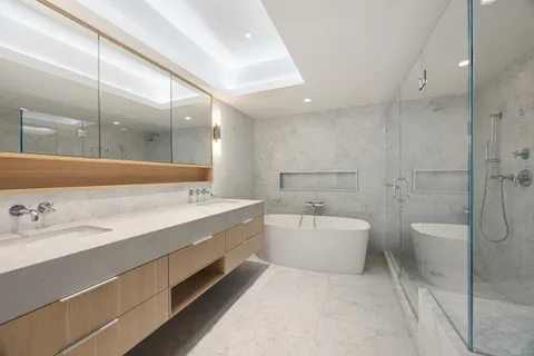 a spacious bathroom with a bathtub shower sink and toilet