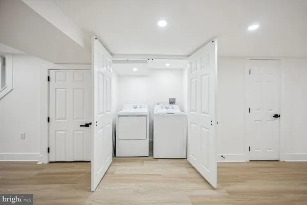 a view of a hallway with closet and wooden shelves
