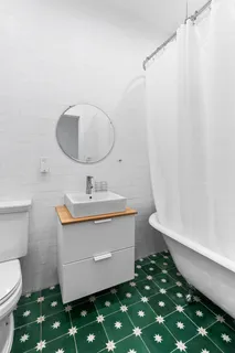 a bathroom with a sink toilet and a mirror