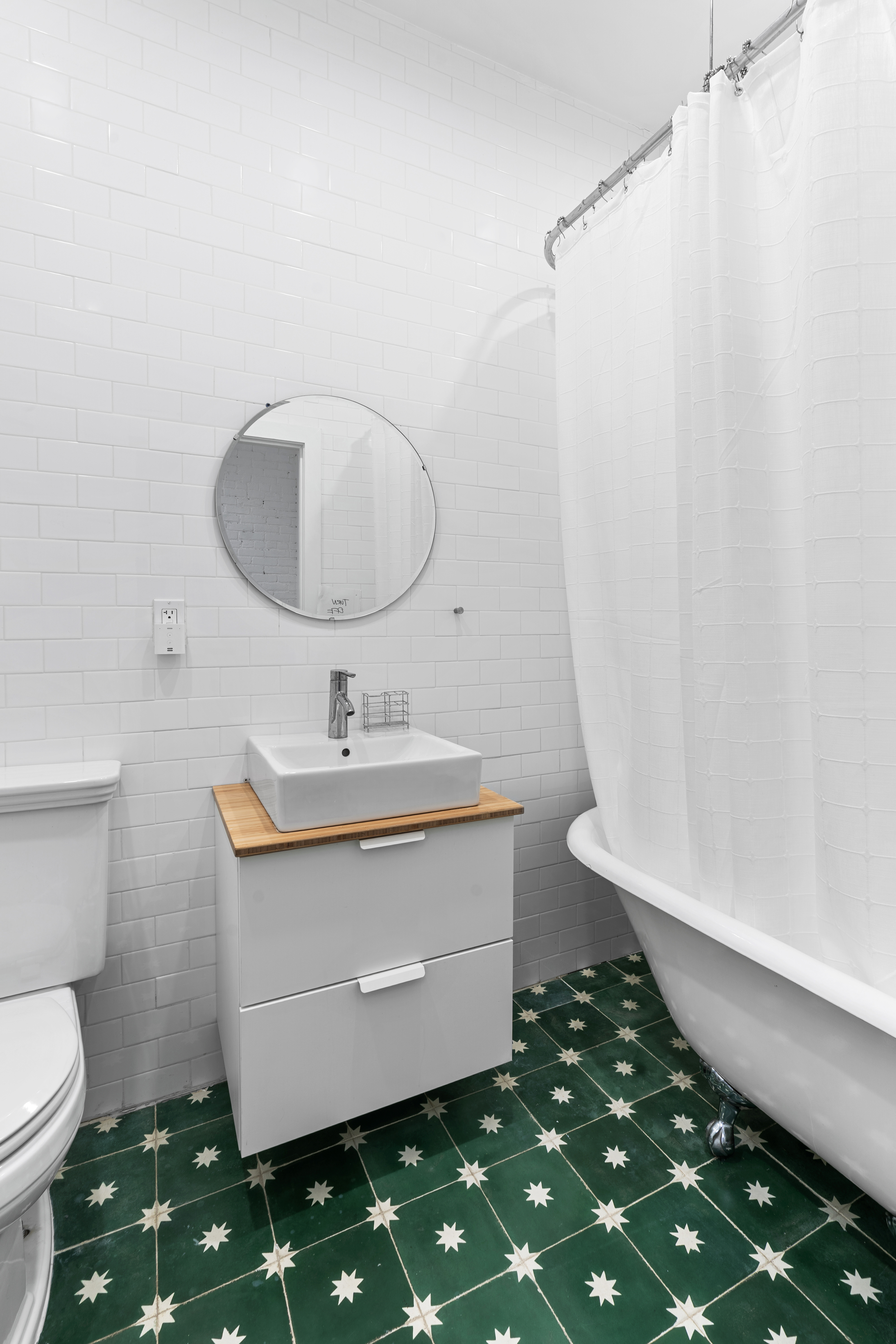 660 Saint Marks Avenue Brooklyn, NY 11216 - Photo 11 of 21 a bathroom with a sink toilet and a mirror