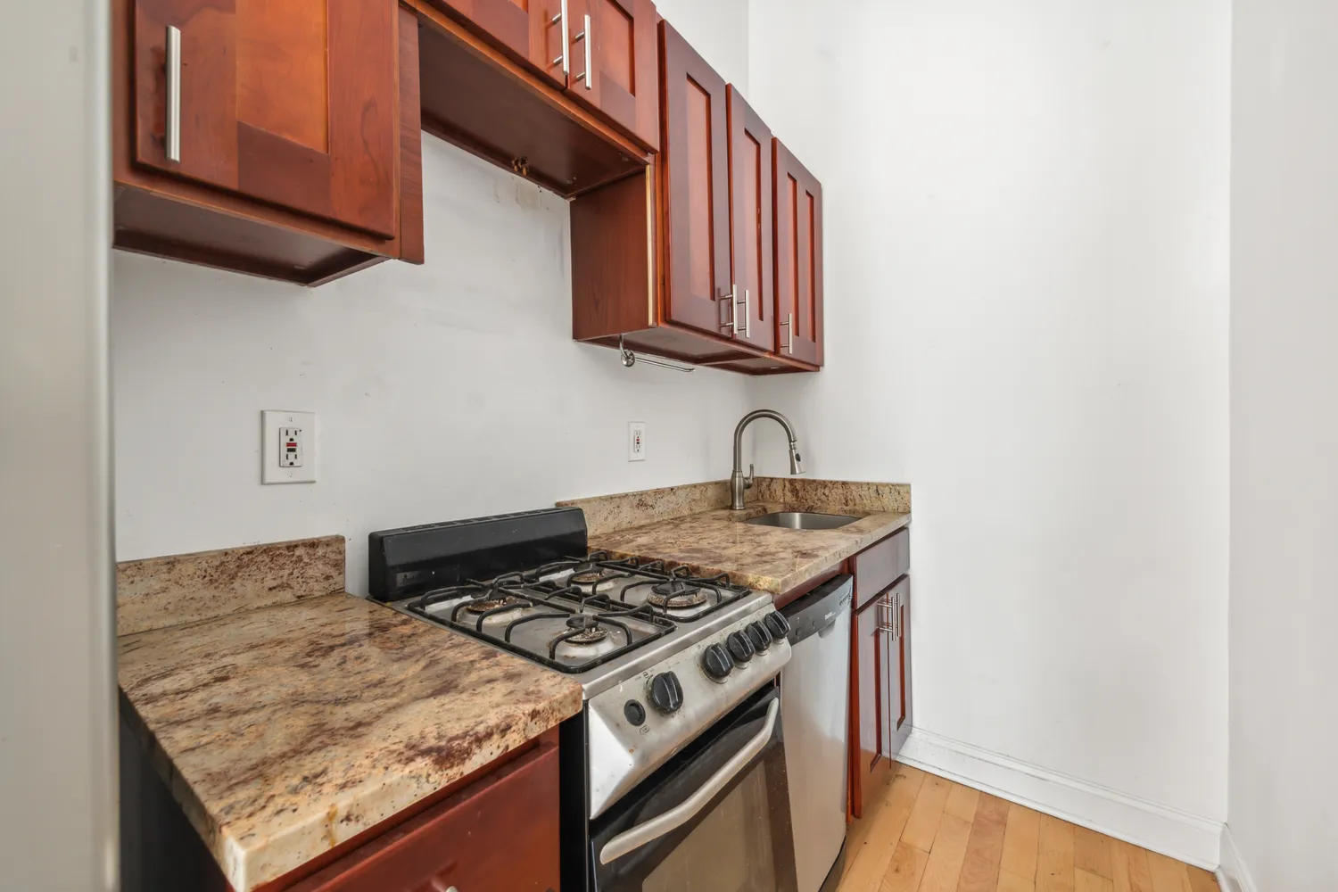 a white stove top oven sitting inside of a kitchen