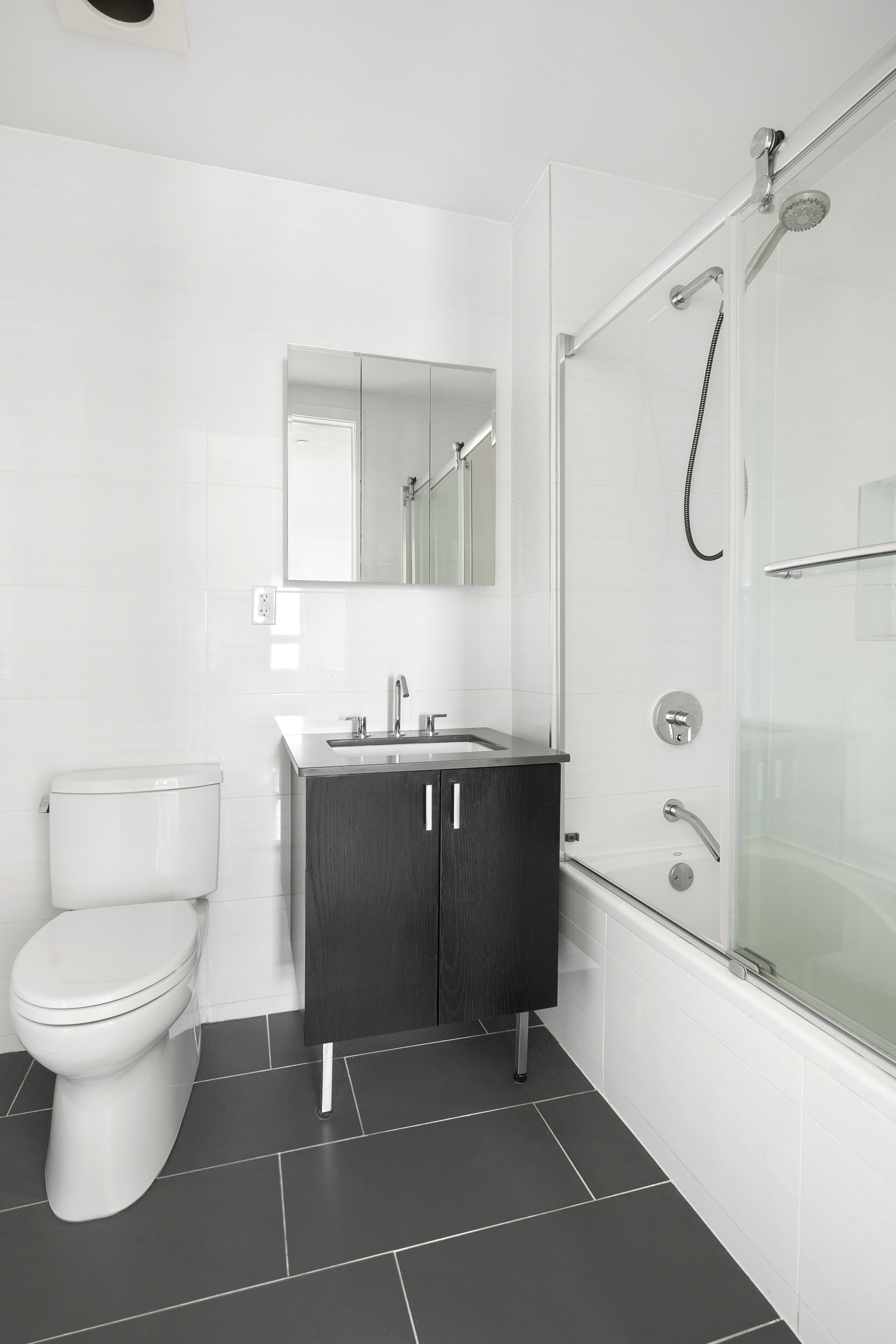 63-34 Fresh Pond Road, Unit 3D Queens, NY 11385 - Photo 7 of 14 a bathroom with a sink a toilet and shower