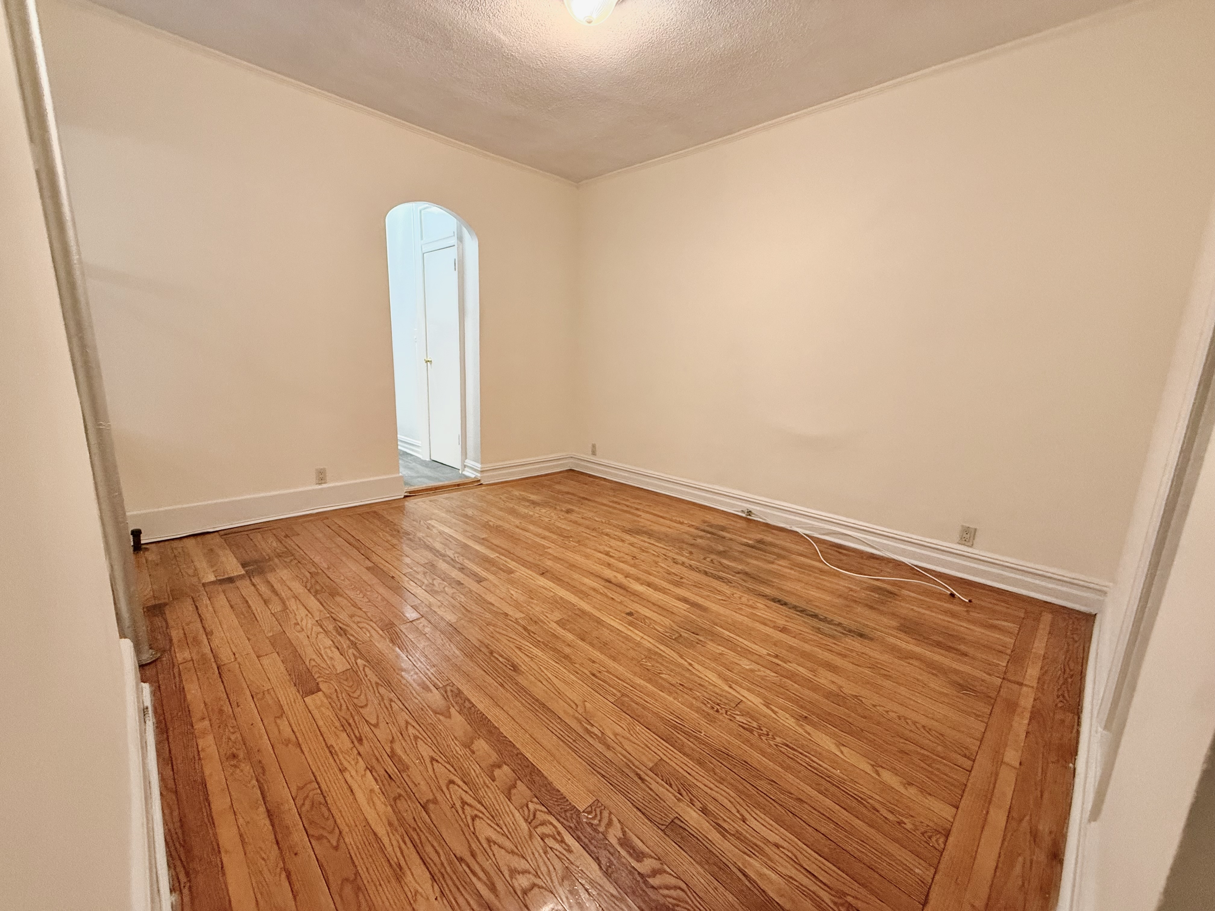 30 Seaman Avenue, Unit 1 Manhattan, NY 10034 - Photo 3 of 5 a view of empty room with wooden floor