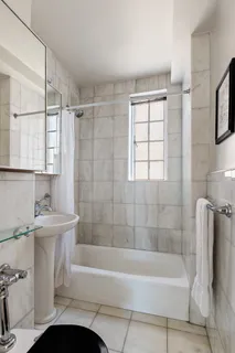 a bathroom with a tub a sink and a shower