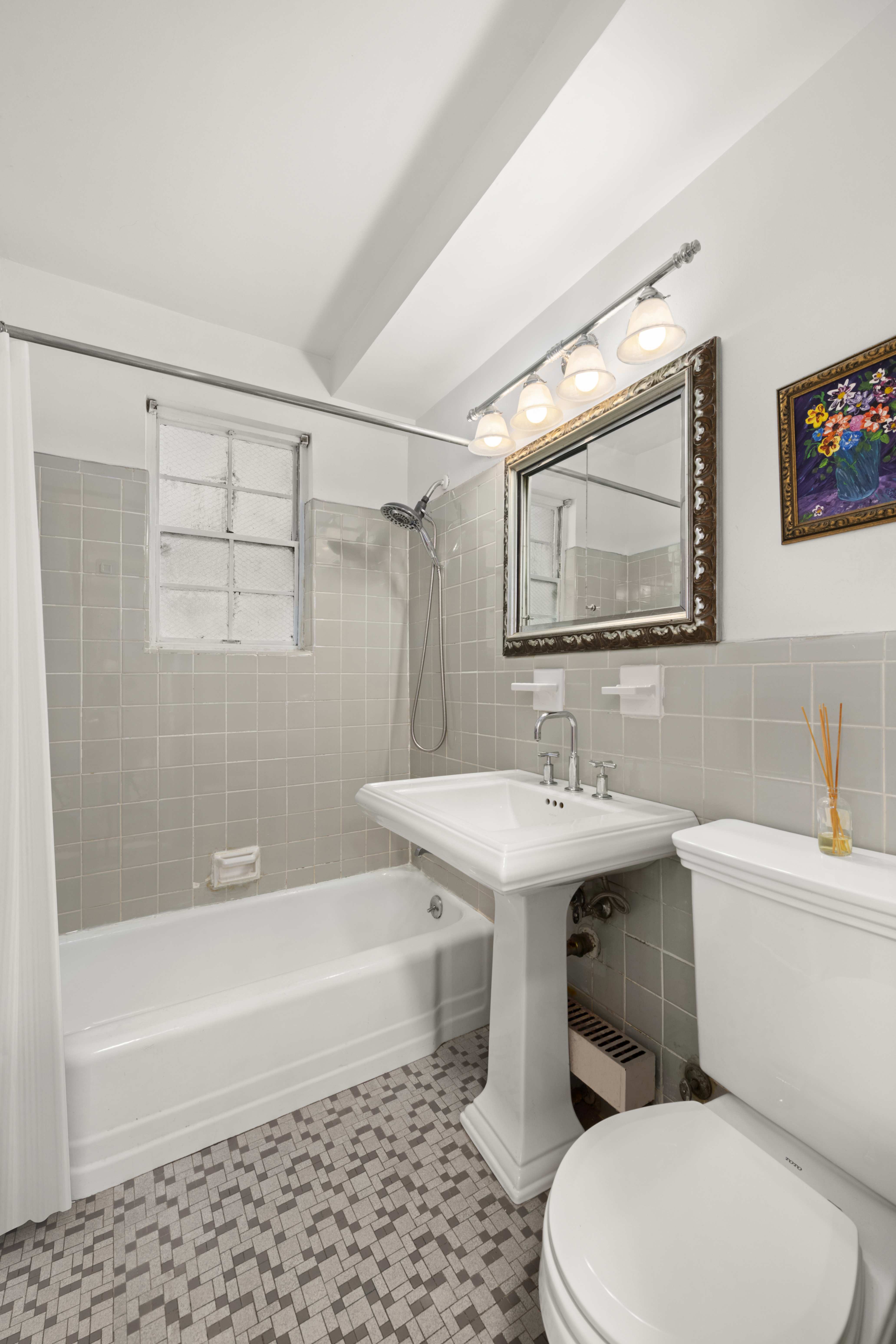 347 East 53rd Street, Unit 2B Manhattan, NY 10022 - Photo 5 of 7 a bathroom with a sink a toilet and shower