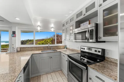 a kitchen with stainless steel appliances granite countertop a stove and a sink