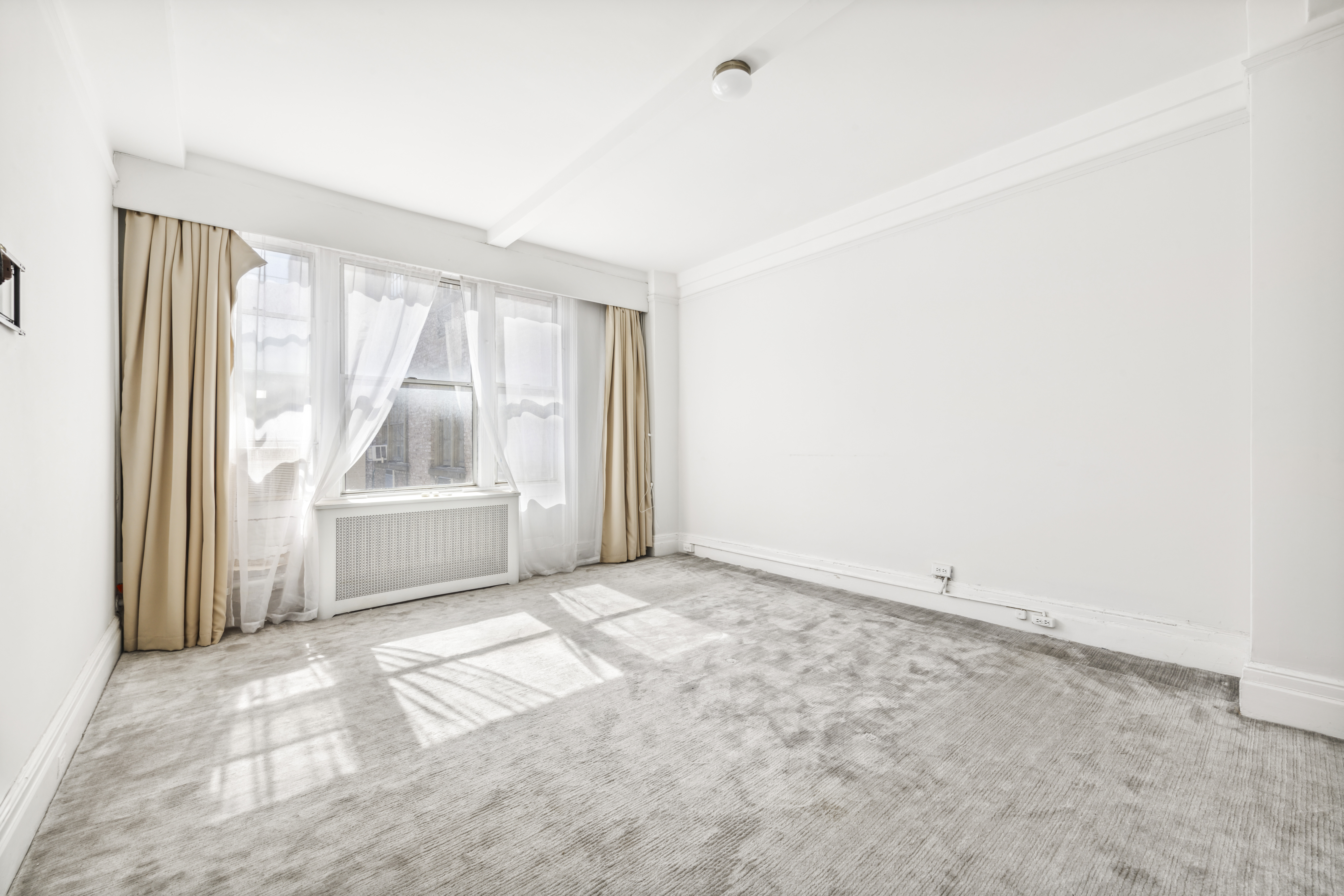 130 East 67th Street, Unit 9C Manhattan, NY 10065 - Photo 14 of 20 a view of a room with a large window