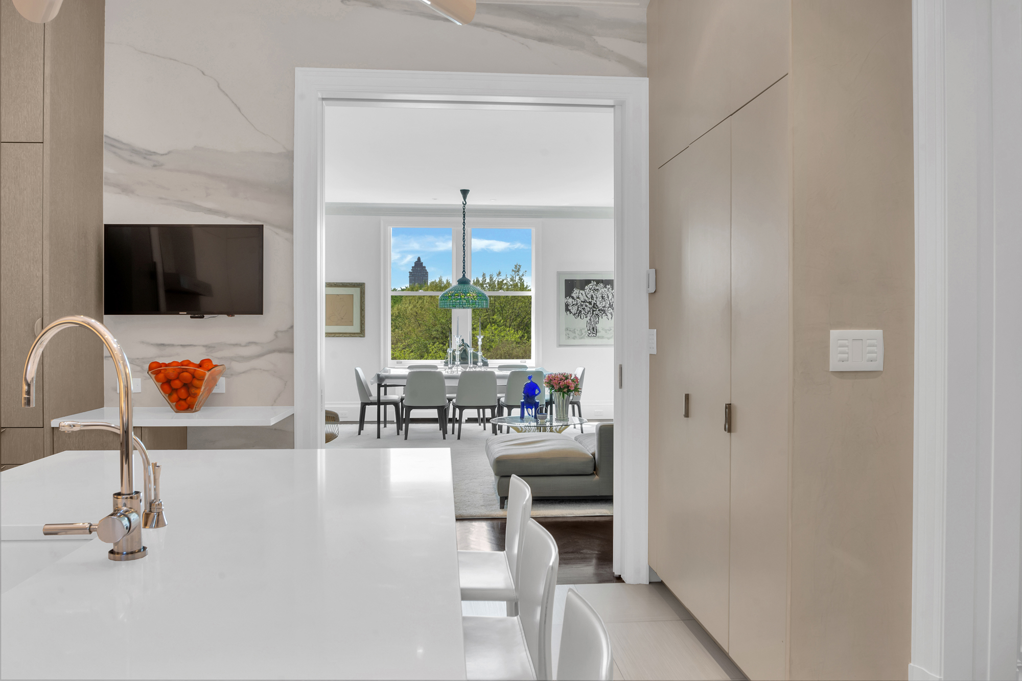 988 5th Avenue, Unit 6 Manhattan, NY 10075 - Photo 3 of 14 a hallway with a couch and a flat screen tv
