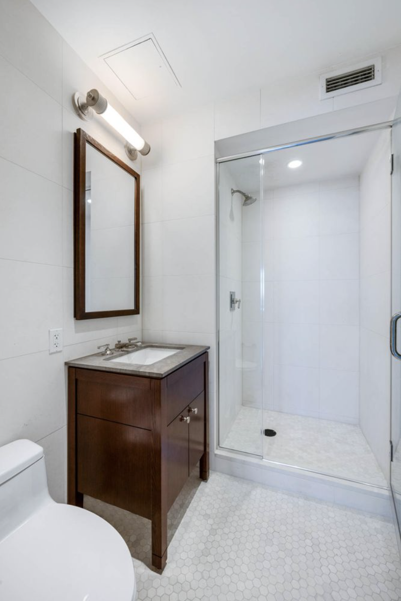 80 Riverside Boulevard, Unit 23C Manhattan, NY 10069 - Photo 13 of 19 a bathroom with a sink toilet and shower