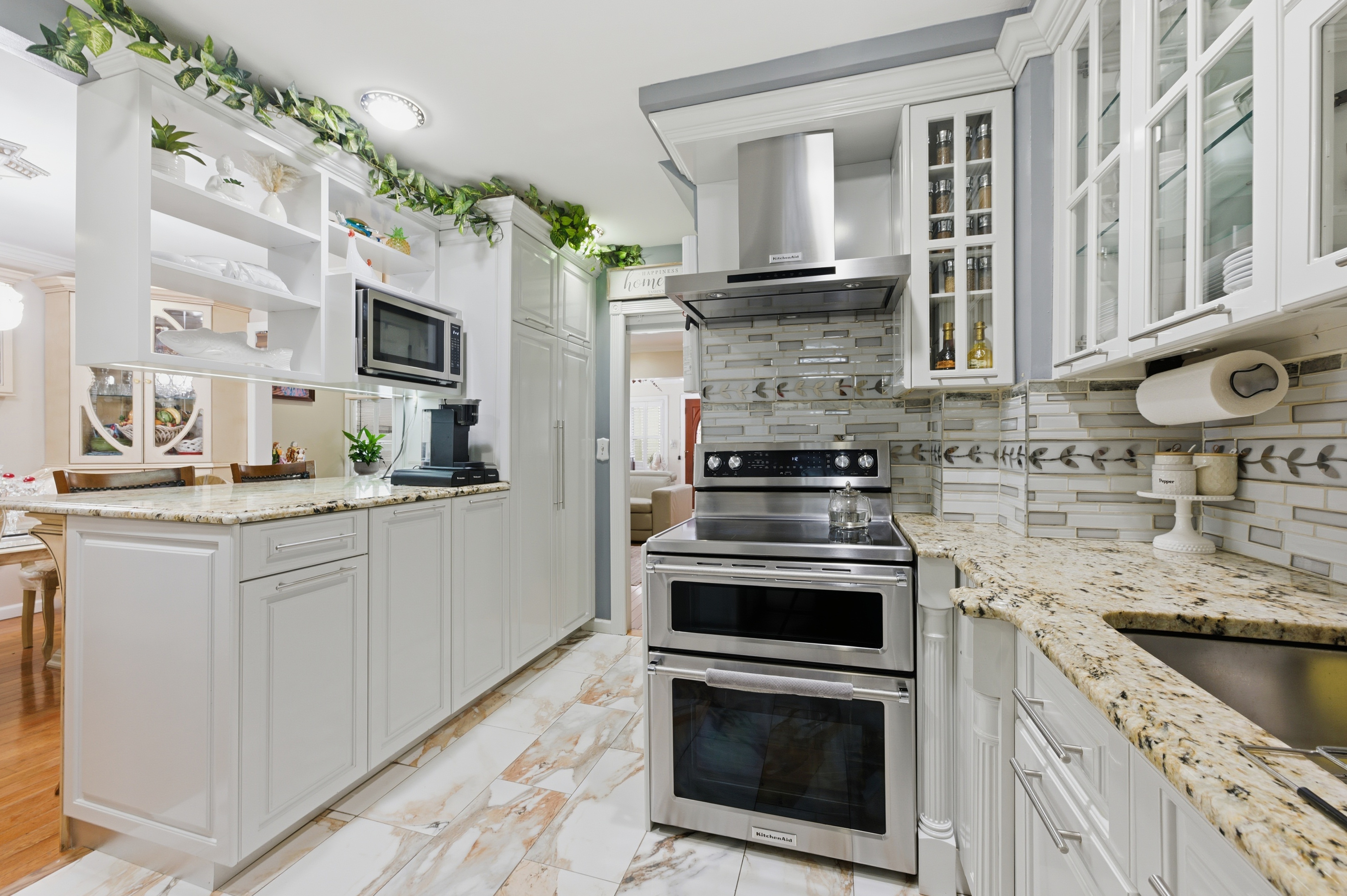 150-22 114th Road Queens, NY 11434 - Photo 2 of 22 a kitchen with stainless steel appliances granite countertop a stove a sink and a microwave