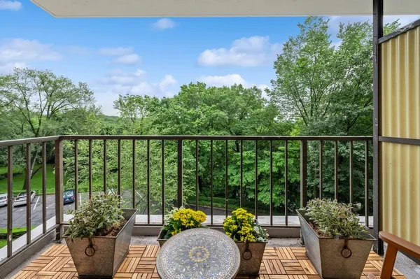 a view of balcony with furniture and garden