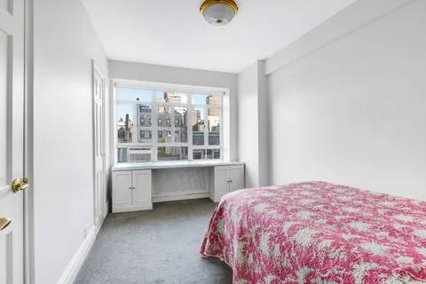 a bathroom with a sink a toilet a mirror and a glass door shower