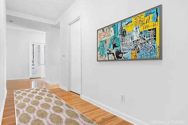 252 7th Avenue, Unit 10I Manhattan, NY 10001 - Photo 15 of 25 a bedroom with a bed and painting on the wall