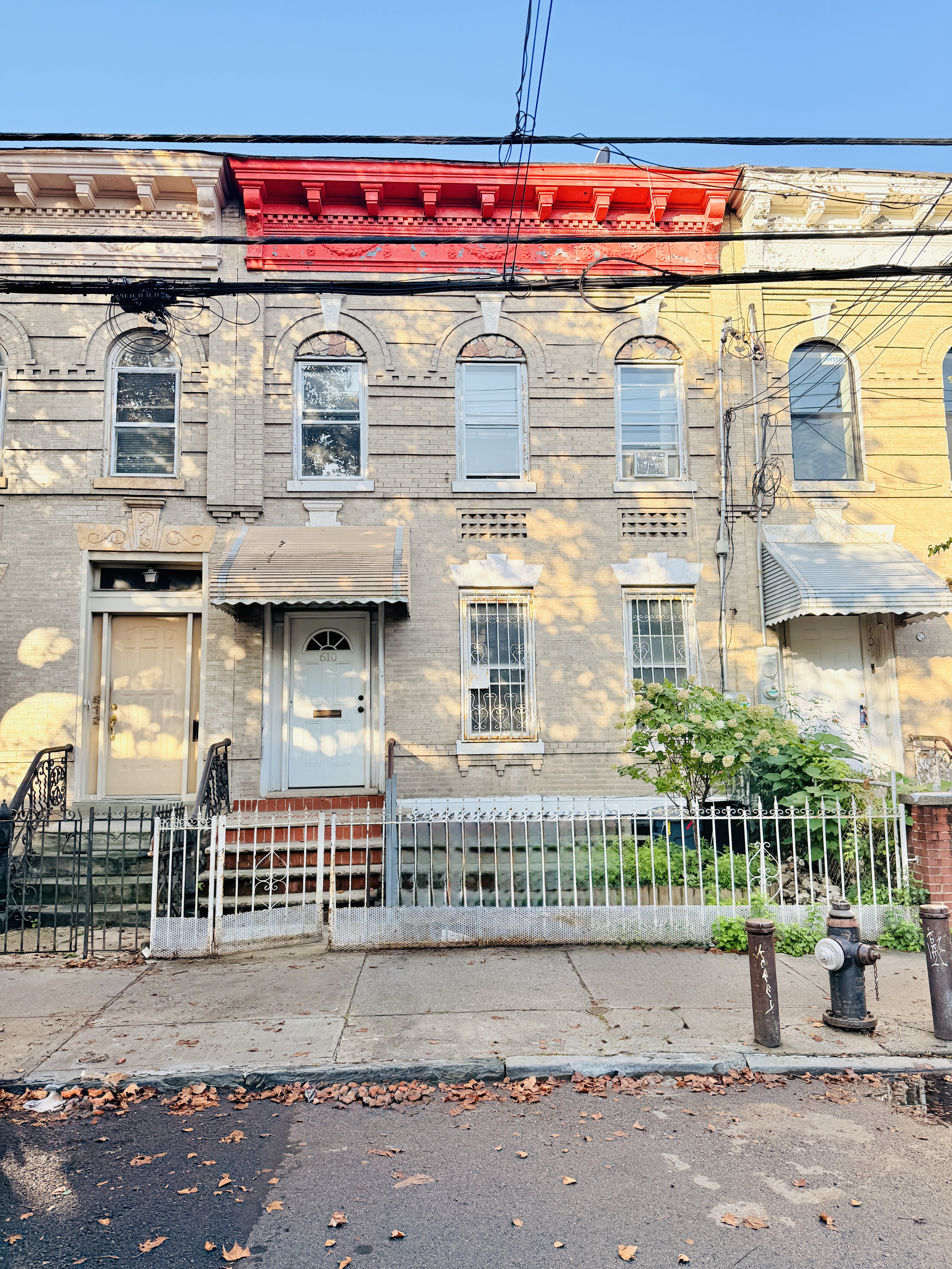 610 Ashford Street Brooklyn, NY 11207 - Photo 27 of 28 a front view of a building with a garage