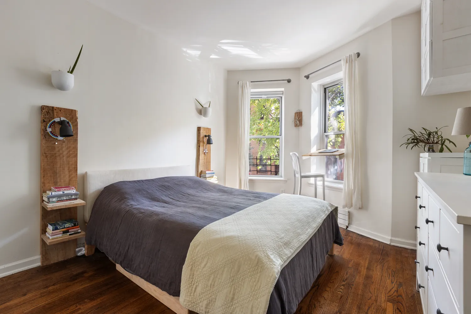 a bedroom with a bed and wooden floor
