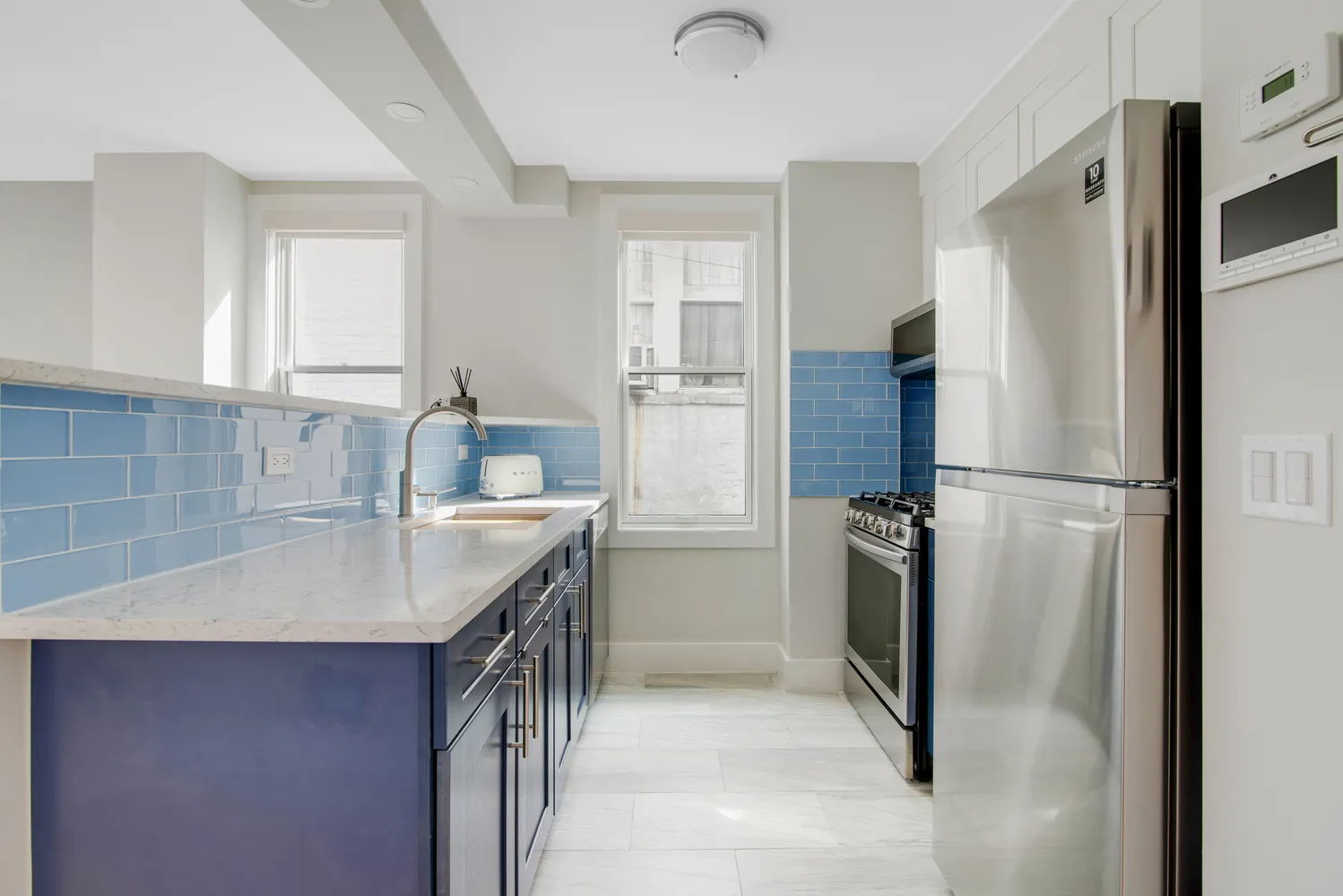 a kitchen with a refrigerator sink and cabinets