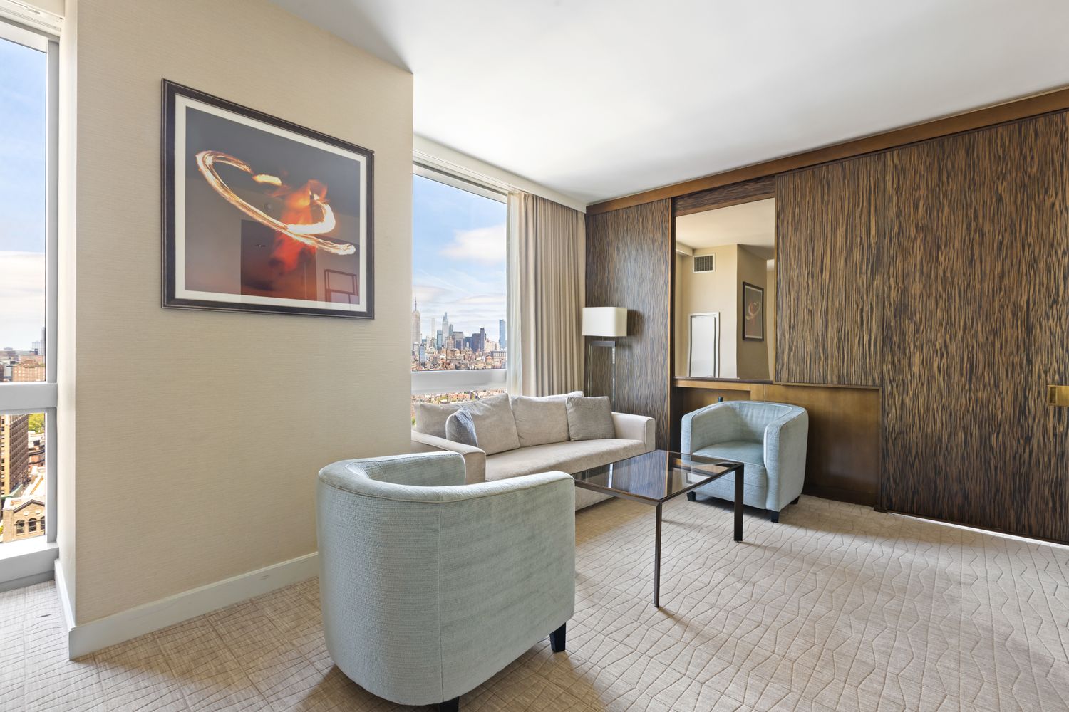 246 Spring Street, Unit 2910 Manhattan, NY 10013 - Photo 2 of 17 a living room with furniture and a window