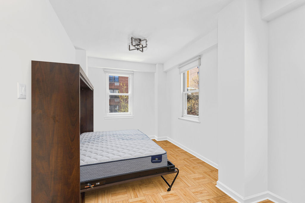 101 West 12th Street, Unit 5V Manhattan, NY 10011 - Photo 22 of 26 a living room with furniture and a window