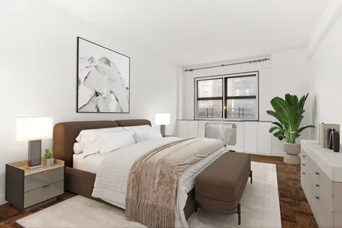 a bedroom with a bed and a potted plant