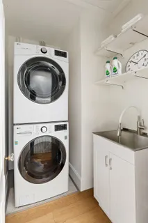 a utility room with sink washer and dryer