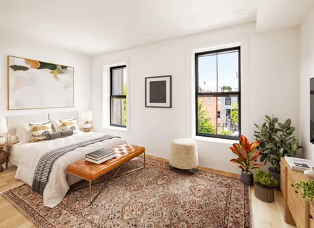 a bedroom with a bed and a potted plant