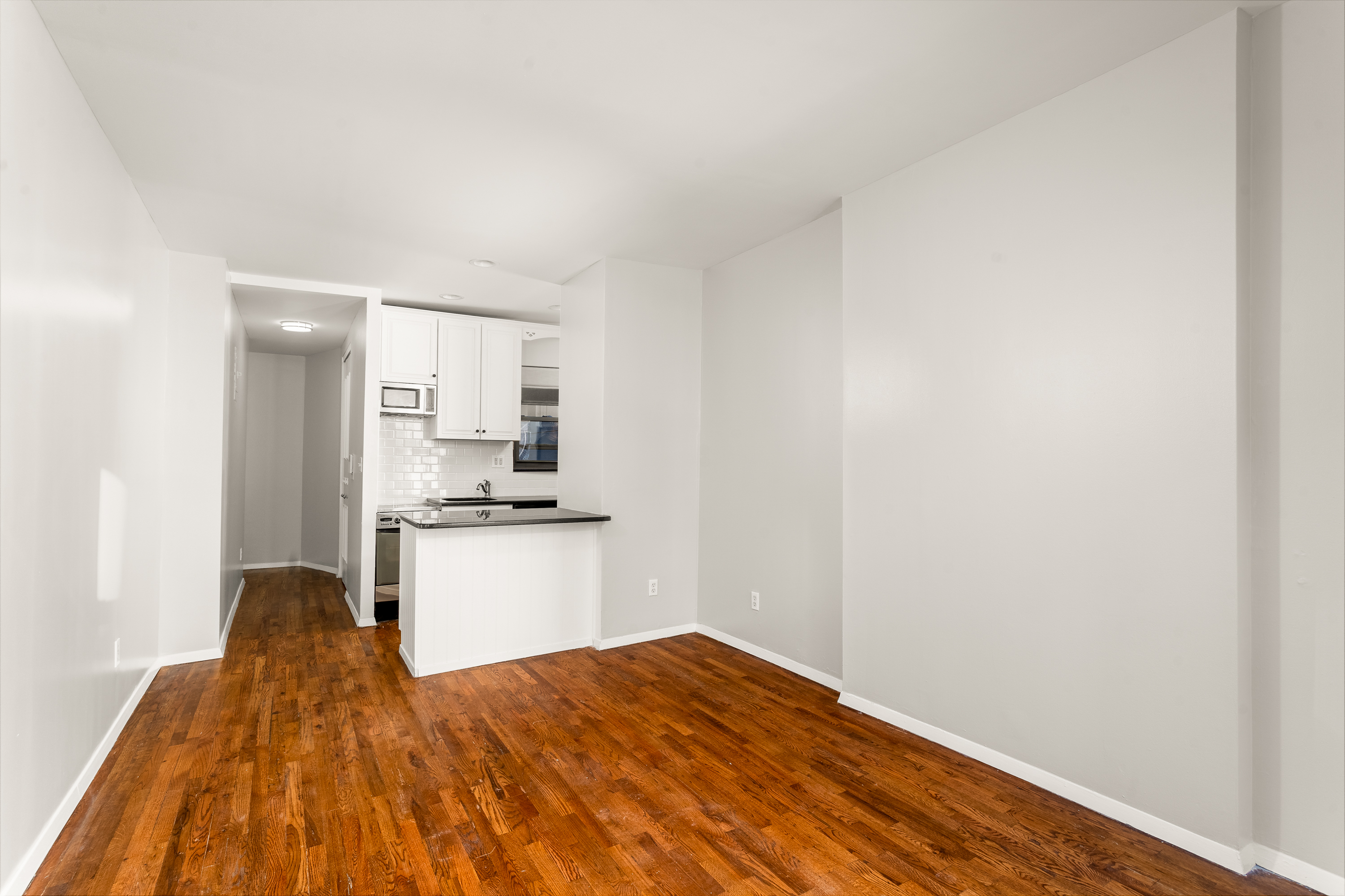 160 East 91st Street, Unit 7N Manhattan, NY 10128 - Photo 2 of 13 a kitchen with a refrigerator and a stove top oven