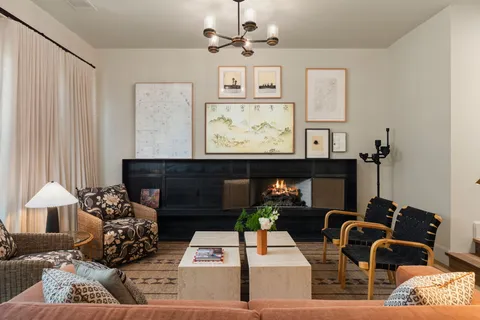 a living room with furniture ceiling fan and a large window