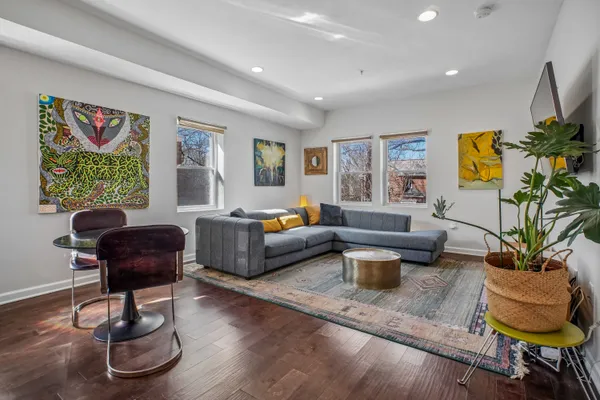 a living room with furniture and a potted plant