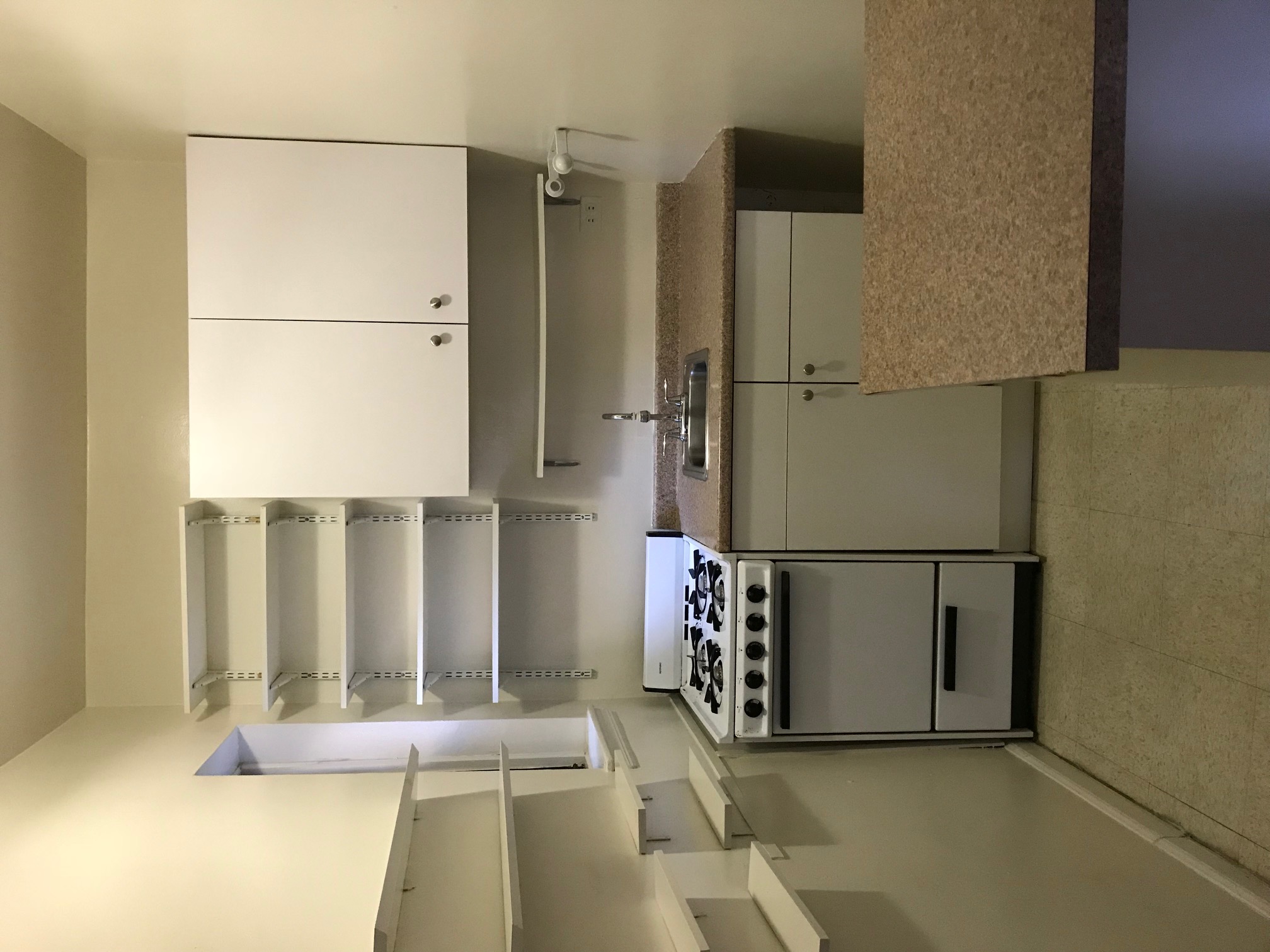153 East 43rd Street, Unit 5A Manhattan, NY 10017 - Photo 5 of 7 a kitchen with cabinets and appliances
