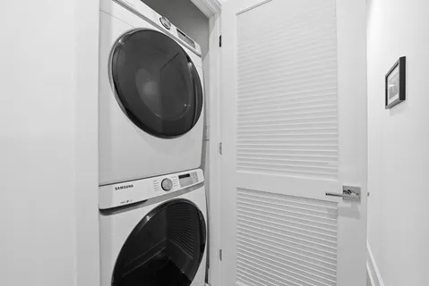 a view of a hallway with washer and dryer