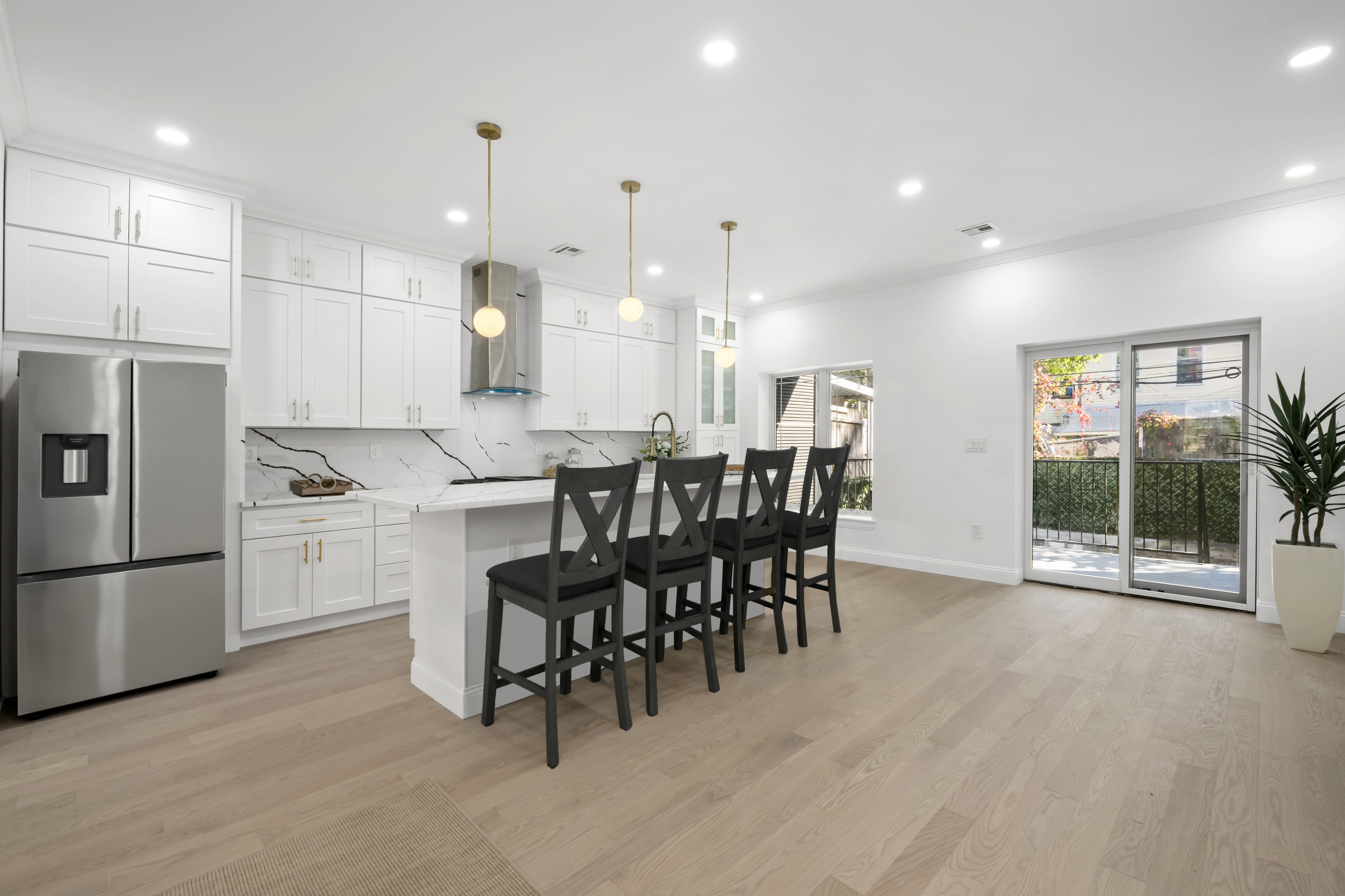 84 Himrod Street Brooklyn, NY 11221 - Photo 6 of 35 a kitchen with kitchen island a dining table chairs stainless steel appliances and cabinets